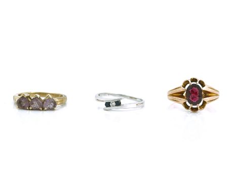 THREE GOLD AND GEM SET RINGS (3)Comprising; a 9ct gold ring, claw set with an oval cut garnet, Birmingham 1919, ring size P, 