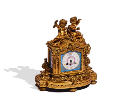 A FRENCH ORMOLU AND SEVRES-STYLE PORCELAIN-MOUNTED MANTEL CLOCKIn the Louis XVI style, last quarter 19th CenturySurmounted by