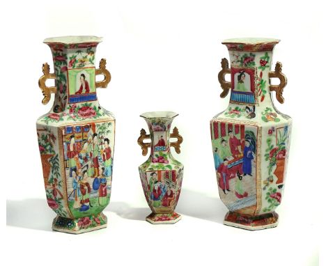 THREE CANTON FAMILLE- ROSE HEXAGONAL TWO-HANDLED VASES19th  centuryOf similar form, each painted with figurative panels, agai