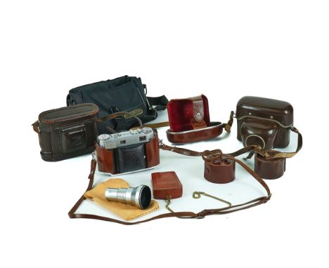 THREE CAMERAS, A LIGHT METER AND A LENS (5)To include, a Kodak Retina III C with a Schneider-Kreuznach 50mm f2 lens, a Zeiss 