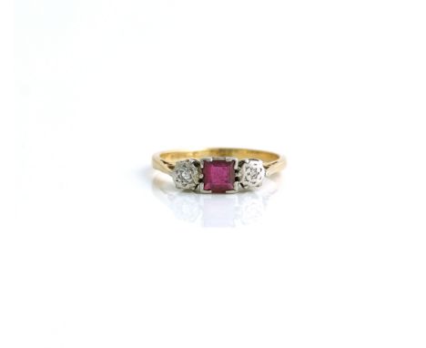 A GOLD AND PLATINUM, RUBY AND DIAMOND SET THREE STONE RINGMounted with a square cut ruby at the centre, between two circular 