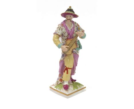 An early 19th century hand-decorated porcelain figure model (probably Berlin) of a Chinese man playing the lute (after a Meis