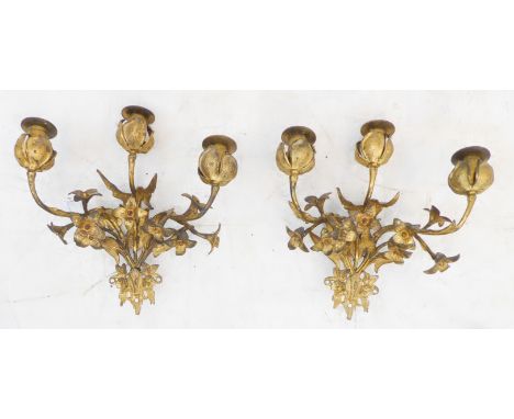 A pair of late 19th to early 20th century three-light gilt-metal wall appliques (for candles): modelled as budding flowerhead