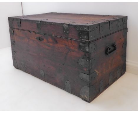 A 19th century stained pine and metal mounted zinc-lined chest/trunk: the hinged lid opening to reveal the trunk department l