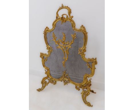 A fine quality late 19th century French gilded ormolu Rococo-style fireguard. The finely worked frame decorated with roses an