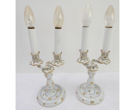 A pair of early 20th century (circa 1915 - 1930) Herend porcelain two-light table candelabra decorated with gilded leaves, pr