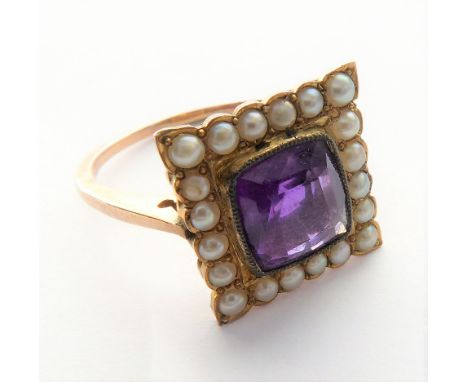 An Edwardian amethyst and seed pearl ring, the central cushion-shaped mixed-cut amethyst to the square border of half pearls,