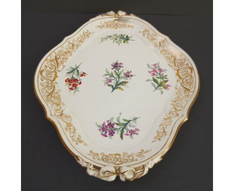 A 19th century two-handled, lozenge-shaped ceramic Worcester tray: the border gilt-decorated with various scrolling foliage, 