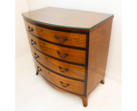 A late 18th century bow-fronted satinwood and rosewood crossbanded chest: the four full-width graduated drawers with oak lini