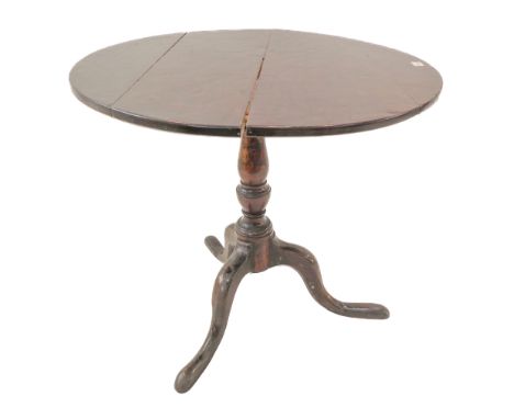 An 18th century George III period circular tilt top oak tripod table (with restorations) and additions: the planked top above