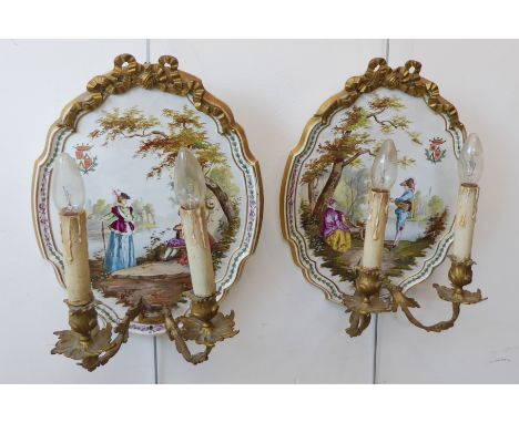 A large pair of French gilt-metal-mounted&nbsp;ceramic two-light electric wall appliques: panelled and decorated with Watteau