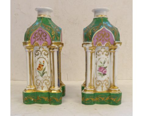 A pair of 19th century Coalport pagoda shaped green enamel and gilt decorated candlesticks. The faceted domed tops supported 