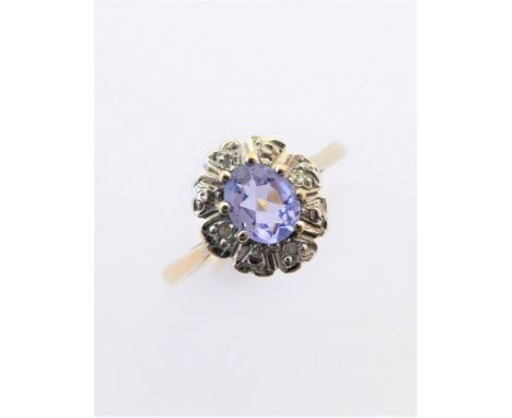 A tanzanite and diamond cluster 9-carat gold ring, ring size K/L