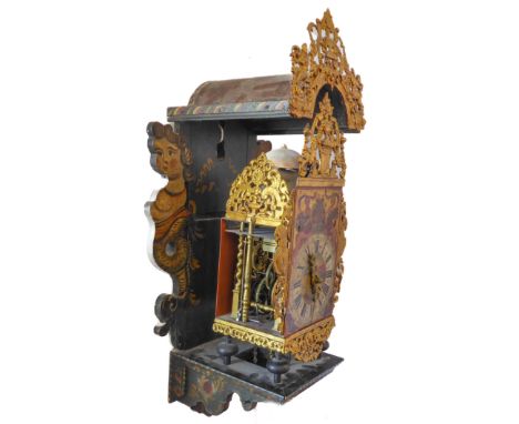 A late 18th / early 19th century Dutch Friesland Stoelklok. The painted arched hood with Rococo- style gilt embossed and pier