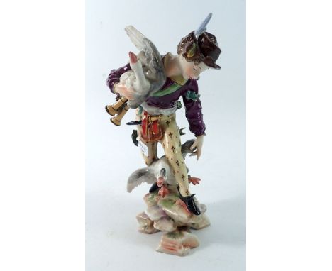 A Volkstedt figure of a Scottish huntsman with two geese and bagpipes, 16cm tall
