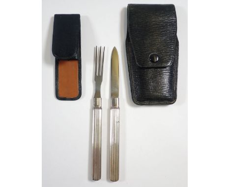 A white metal travelling cutlery set with retractable knife and fork in leather case, by J C Vickery