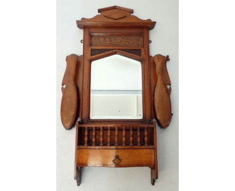 An Edwardian oak hall shelf with mirror and drawer with two clothes brushes, 74cm tall