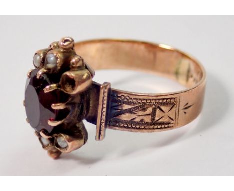 A Victorian garnet and seed pearl ring on gold band - unmarked, 3.3g, size K