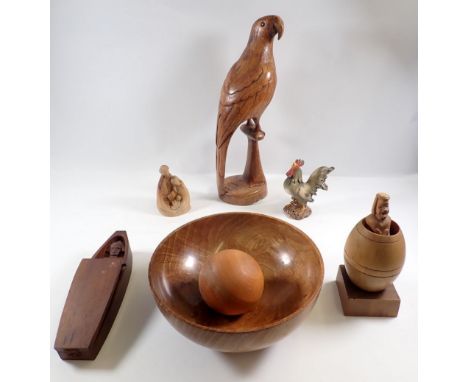 A box of woodenware including carved bowl, parrot etc.