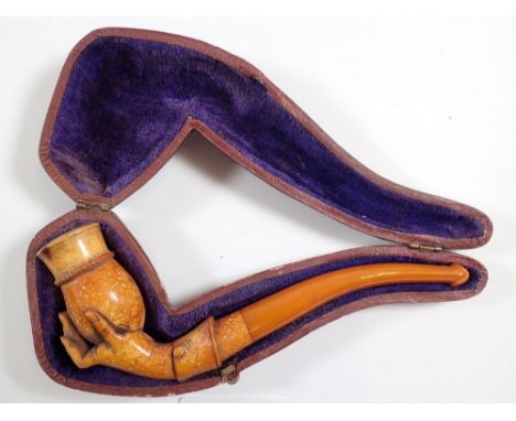 An antique meerschaum and amber pipe carved hand holding a vase, with leather case, 15cm