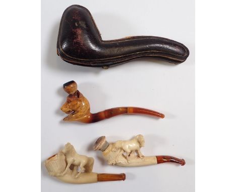 Three antique meerschaum and amber pipe/cheroot holders carved as standing horses and a dogs head (cased) 
