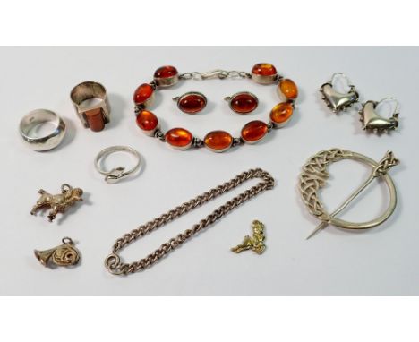 A silver Scottish kilt pin by Thomas Kerr Ebbutt, two silver rings, a silver bracelet, an amber white metal bracelet and earr