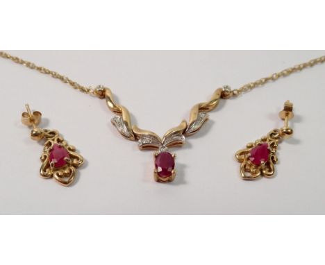 A 9 carat gold necklace set oval cut ruby and chip diamonds on scrollwork setting, 3.6g, 44cm and a pair of 9 carat gold ruby