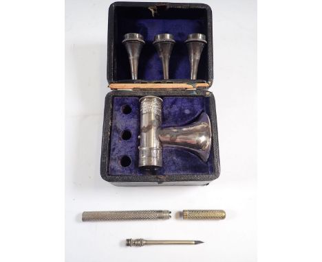 A University College Coxeter silver plated ear syringe boxed and a piercing tool in cylindrical case, 11cm wide