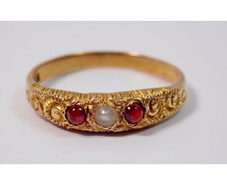 An antique continental gold child's ring set two red stones and seed pearl, 1.1g, size F