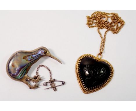 A 9 carat gold framed New Zealand heart form kiwi brooch, 6.1g on gold plated chain and a silver and mother of pearl kiwi bro