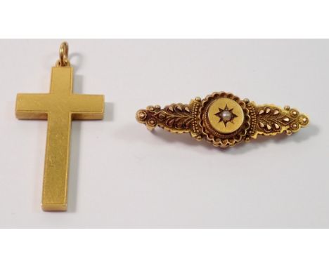 A 15 carat gold crucifix, 3.2g, 3.5cm and a Victorian 15 carat gold brooch with raised decoration and set seed pearl, 2.8g
