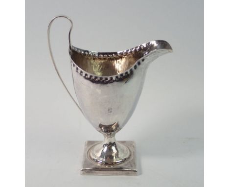A helmet style George III silver cream jug with punched rim, London 1795 by George Gray, 94g, 13.5cm tall