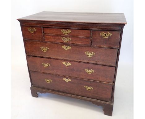 A George II oak chest with two small drawers flanked by two short drawers all over three long drawers on bracket supports, 94