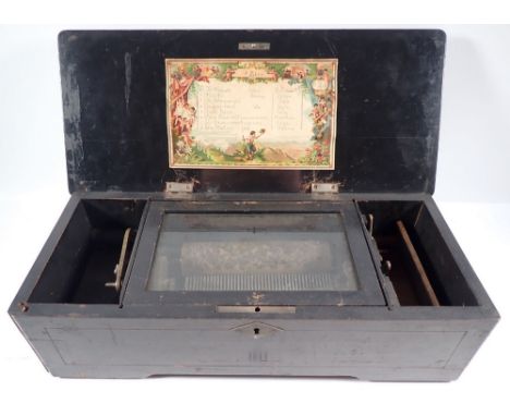 A Victorian cylinder music box playing eight airs in rosewood case with floral inlay - in need of restoration, 42cm wide