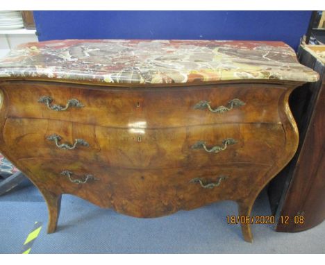 A late 20th century reproduction of a Louis IV walnut bombe commode with a mottled marble top over three long drawers with ca