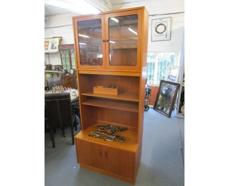 A G-Plan teak side cabinet, twin glazed display doors with internal glass shelves above open shelves and two cupboard base do