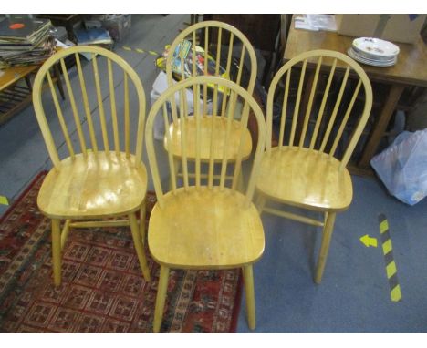 A set of four Ercol style beech seated stick back dining chairs 