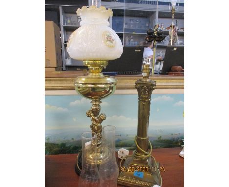 A mid 20th century brass oil lamp with milk glass shade, later converted to electricity, together with two spare glass funnel