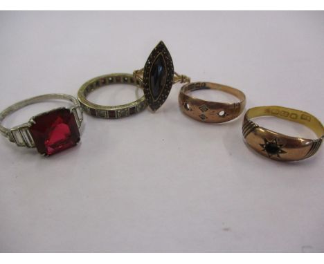 A 9ct gold, ruby and white sapphire full-eternity ring, a white metal and red stone dress ring, and a yellow metal and red st