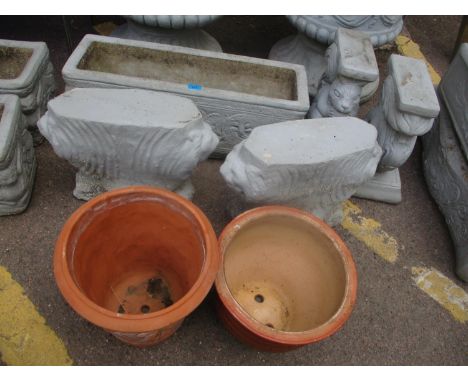 Two pairs of composition stone garden bench stands, a garden planter and two terracotta garden pots 