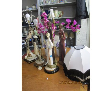 Two Naples figural table lamps and another, two lamp shades with tassels, a pair of tribal figures and two silk flower displa