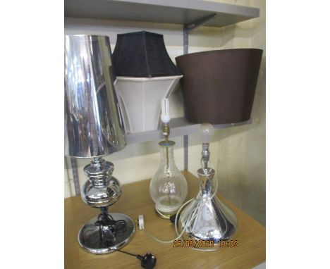 A crackle glass table lamp with central brass rod and two others, together with various lamp shades 