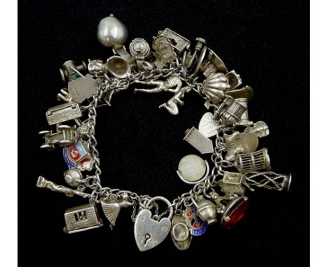 Heavy silver charm bracelet including fly in a spiders web, swan, horse in a stable, dogs, car, ballerina, pearl in a shell, 