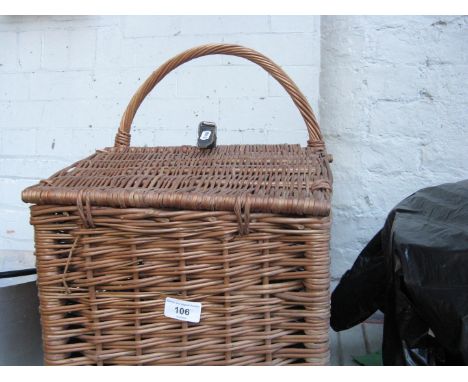 A wicker picnic hamper basket 
