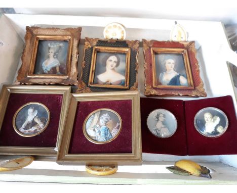 A tray of miniature framed portrait prints with a pair painted 