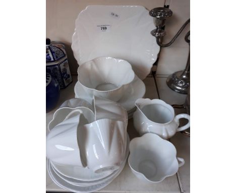 A white Shelley teaset.Condition report : 1 large plate - in good condition 6 side plates - all in good condition 1 sugar bow