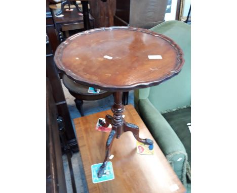 A reproduction tripod table 