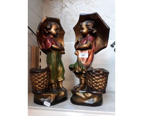 Pair of ceramic ornaments = boy and girl holding umbrellas 