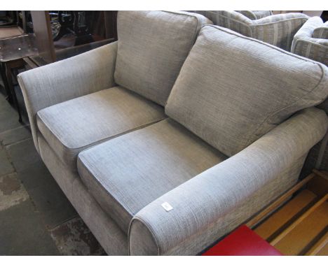 A modern light biege 2 seater sofa 