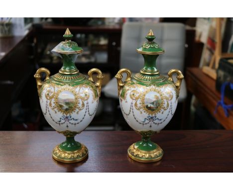 Pair of Royal Worcester lidded vases with landscape panels gilt handles model 2160 Rd No 374254. 25cm in Height 